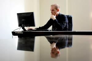 A business professional working on a Windows computer.