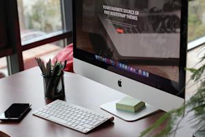 A Mac computer at an office desk.