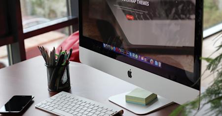 A Mac computer at an office desk.