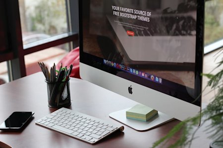 A Mac computer at an office desk.