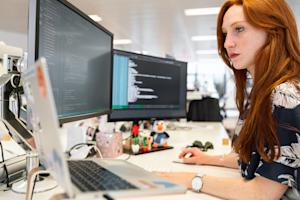 A person working on a computer at their desk.