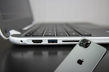 A chromebook and an iPhone, connected via remote access software.