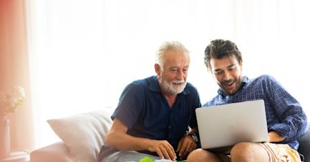 Two men remotely accessing a laptop using Splashtop while sitting on a couch