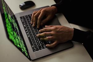 A person typing on a laptop.