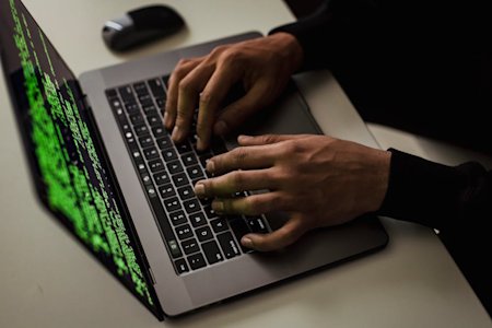 A person typing on a laptop.