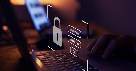 A person typing their login credentials on a keyboard.