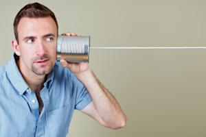 Man holding a tin can as a communication device