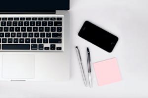 A computer and smartphone on an office desk.