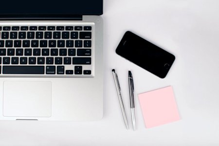A computer and smartphone on an office desk.
