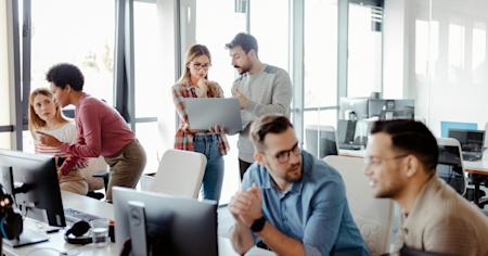 A team of IT Pros using remote management tools in the office.