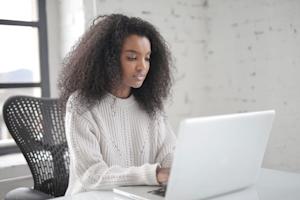 A woman using a computer.