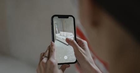 An AR app displaying a sofa in a real room.