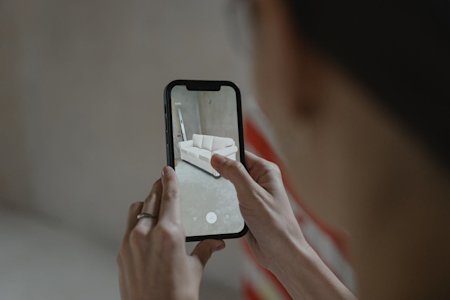 An AR app displaying a sofa in a real room.