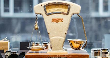Vintage scale in a storefront window balancing two different bowls.