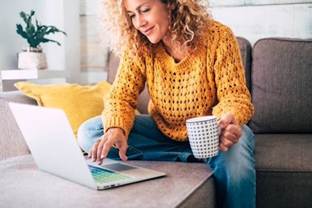 IT professional working remotely on a couch with Splashtop for seamless remote access