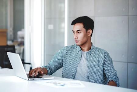 Man learning how IT is navigating the changing work environment with a distributed workforce