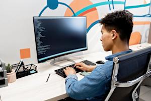 An IT technician working on a computer.
