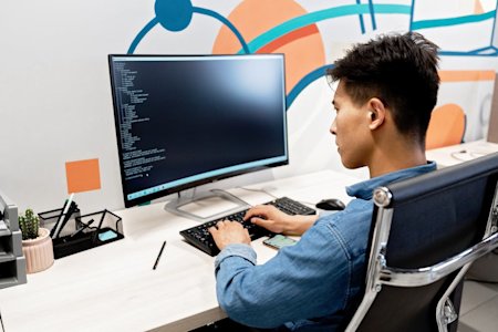 An IT technician working on a computer.