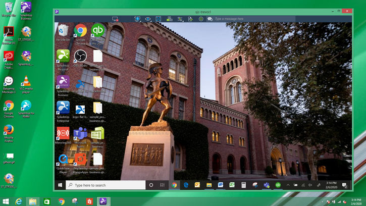 A computer desktop displays an open remote connection window showing a university building with a Trojan statue. Various app icons are visible on the desktop, and the taskbar is at the bottom.