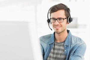 An IT technician on a computer providing remote support to an end-user.