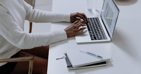 A person typing on a laptop.