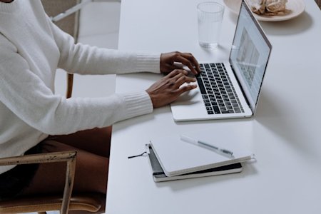 A person typing on a laptop.
