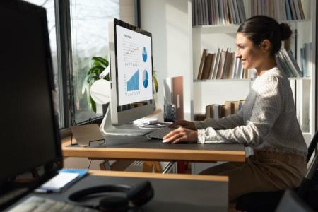 A woman using Splashtop remote desktop software on a Mac computer